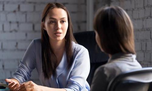 Mental health professional speaking with a patient during therapy